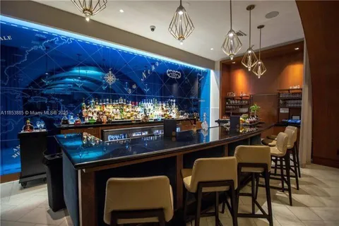 a kitchen with a table chairs and outdoor seating