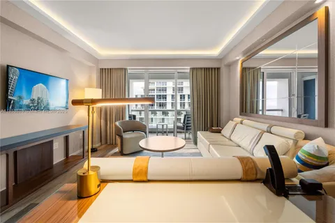 a bedroom with a large bed and a balcony view