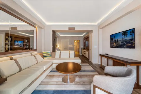 a large bedroom with furniture and flat screen tv