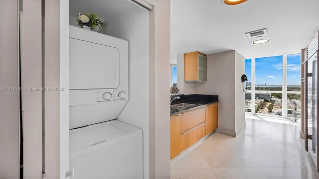 a kitchen with stainless steel appliances granite countertop a refrigerator a stove and a more cabinets