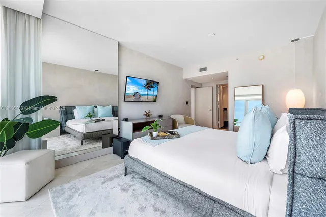 a bedroom with bed and a couch