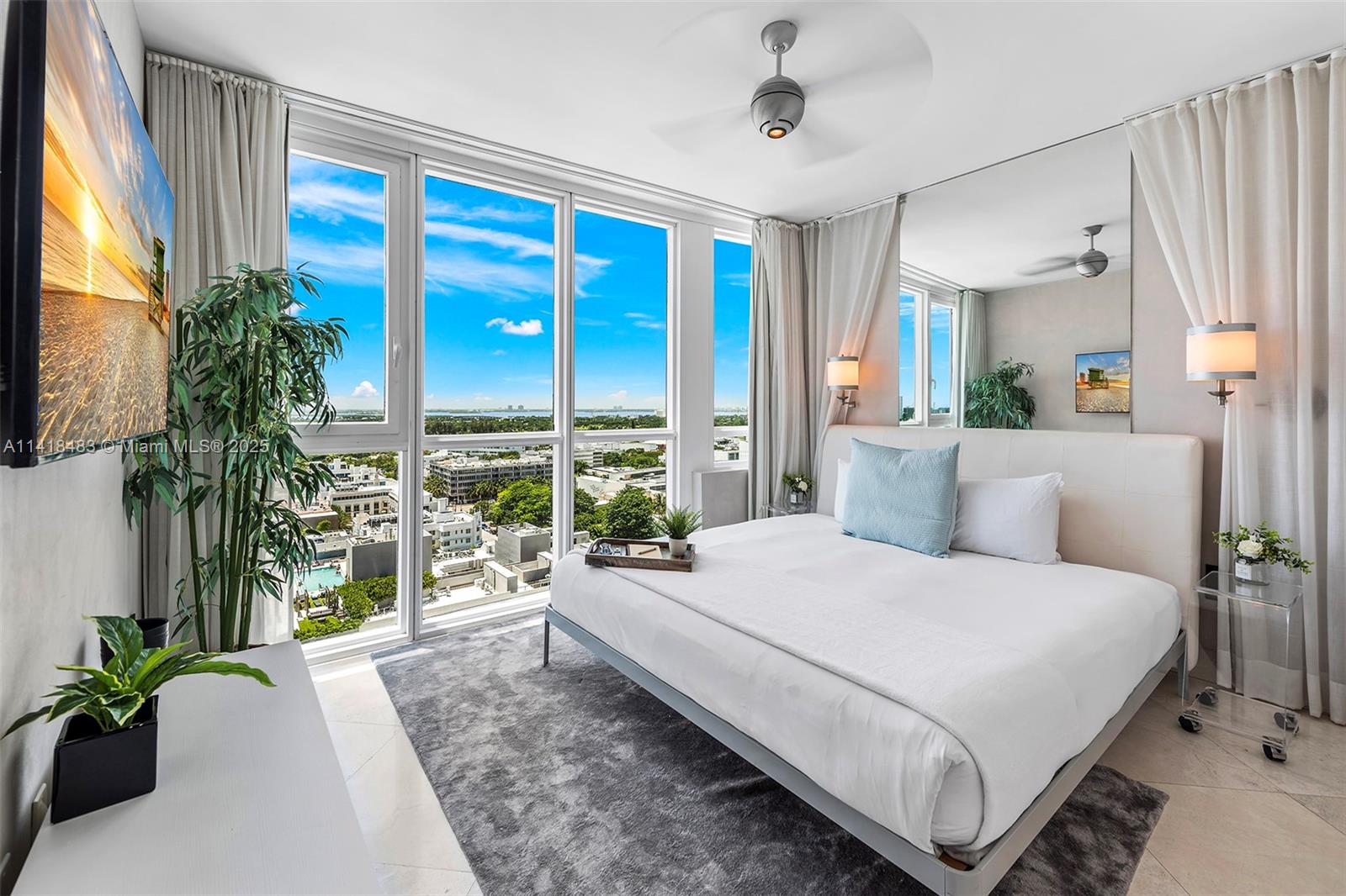101 20th Street, Unit 2102 Miami Beach, FL 33139 - Photo 31 of 40 a bedroom with a large bed and a large window