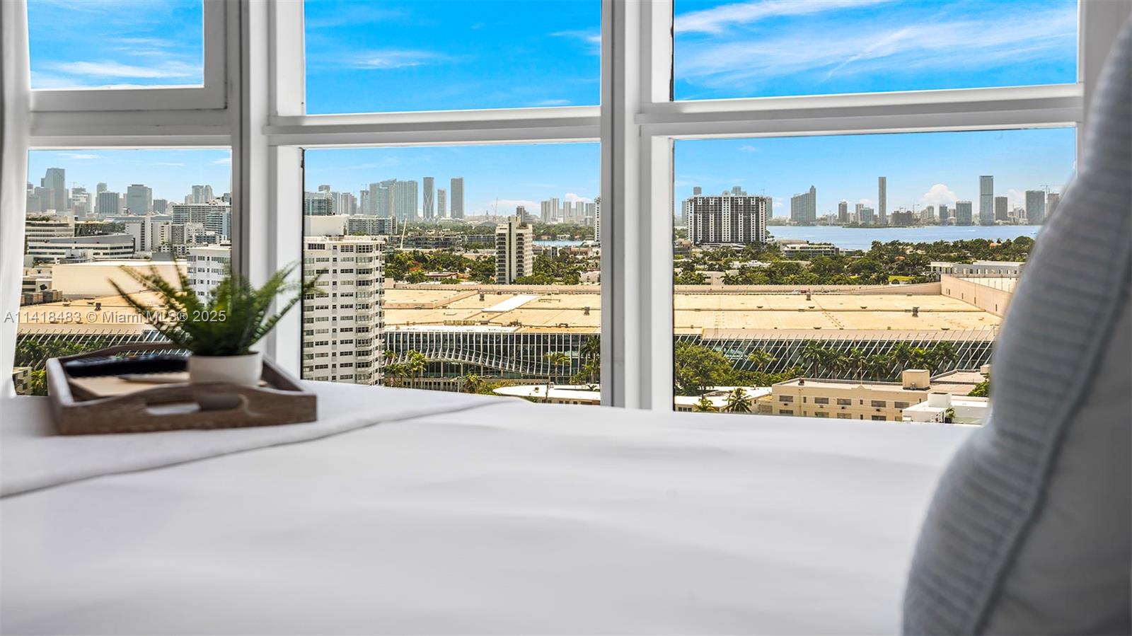 101 20th Street, Unit 2102 Miami Beach, FL 33139 - Photo 34 of 40 a living room with a floor to ceiling window next to a yard