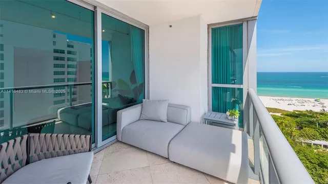 a balcony with table and chairs