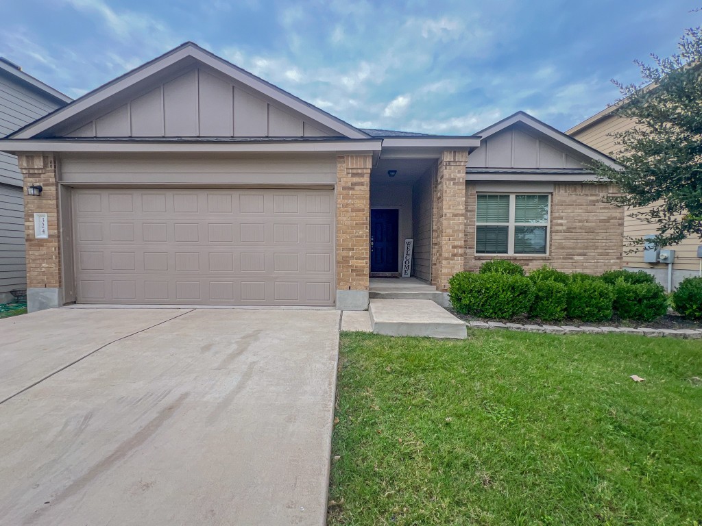 324 Druse Lane Jarrell, TX 76537 - Photo 1 of 29 a front view of a house with a yard and garage