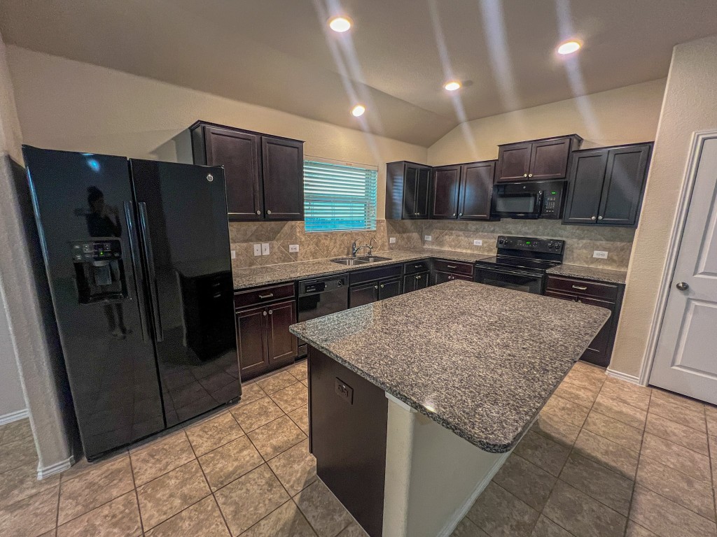 324 Druse Lane Jarrell, TX 76537 - Photo 13 of 29 a kitchen with stainless steel appliances granite countertop refrigerator oven and a sink