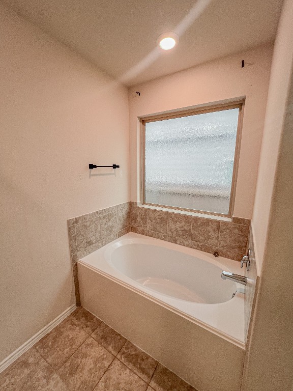 324 Druse Lane Jarrell, TX 76537 - Photo 22 of 29 a spacious bathroom with a bathtub and a window