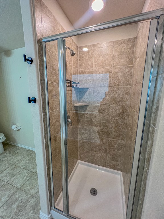 324 Druse Lane Jarrell, TX 76537 - Photo 23 of 29 a bathroom with a shower and a toilet