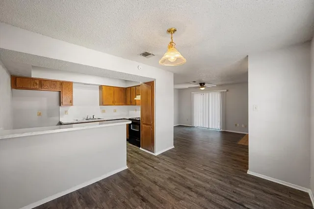 a kitchen with a stove cabinets and wooden floor