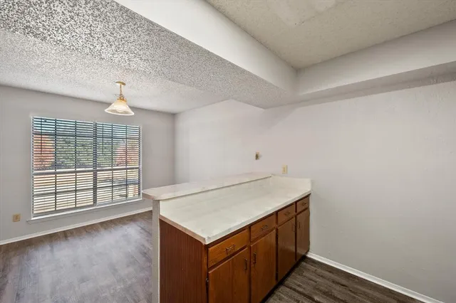 a kitchen with granite countertop cabinets and steel stainless steel appliances