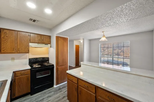 a kitchen with a sink stove and refrigerator