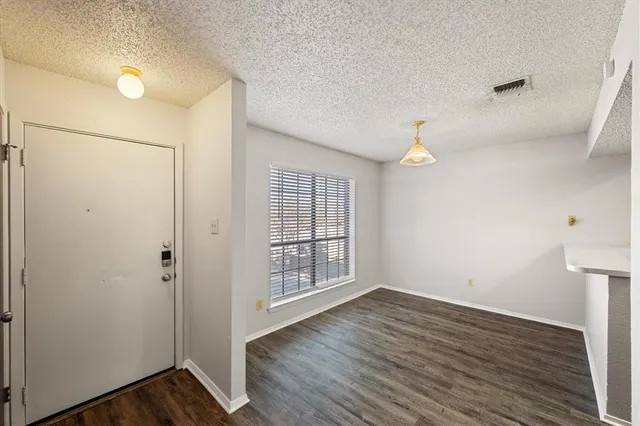 a view of an empty room and wooden floor