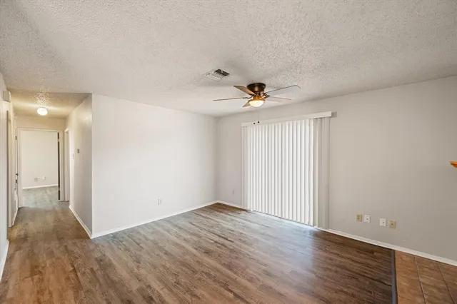 wooden floor in an empty room with a fireplace