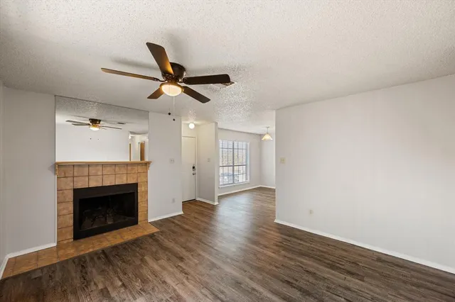 a view of a room with wooden floor and a ceiling fan