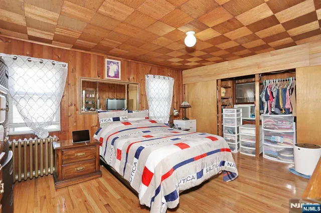 a bed sitting in a bedroom next to a window