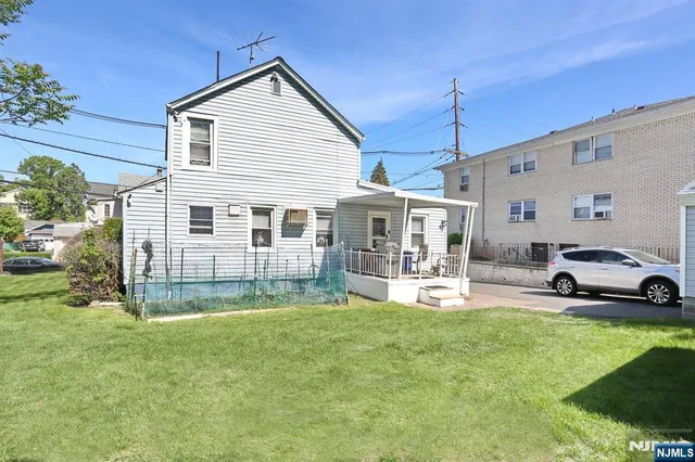 a view of a house with a yard and sitting area