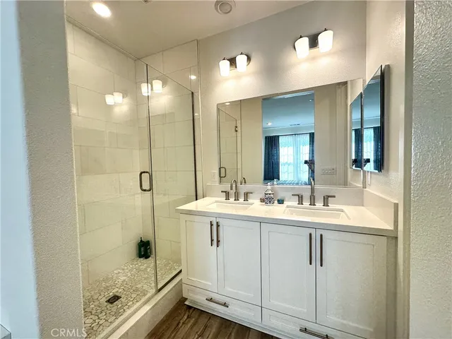 a bathroom with a shower sink and mirror