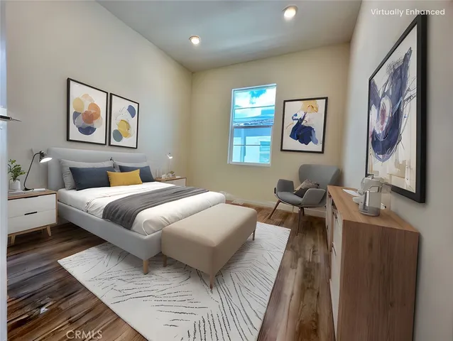 a bedroom with a bed and a painting on the wall