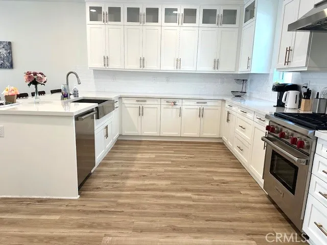 a kitchen with granite countertop a sink and cabinets