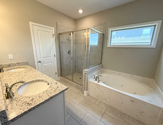 a bathroom with a granite countertop tub a sink and a granite counter tops