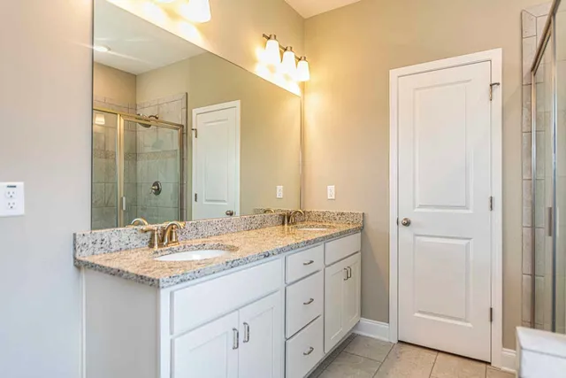 a bathroom with a double vanity sink and a mirror