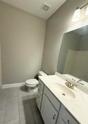 a bathroom with a sink toilet and vanity
