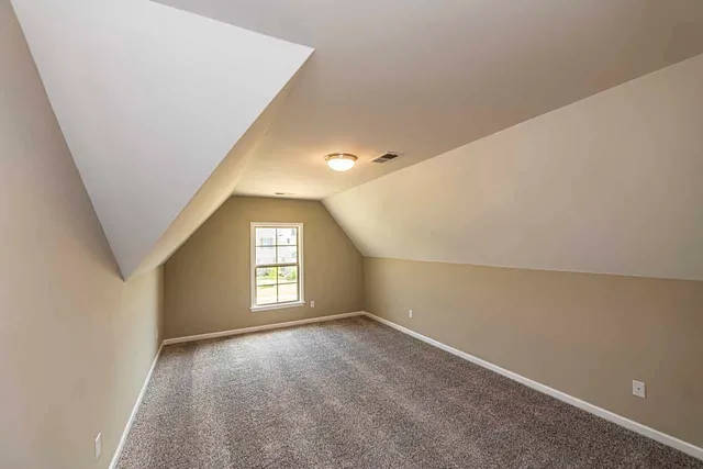 an empty room with windows and closet in a room