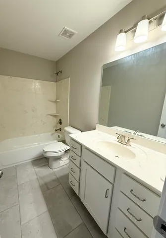 a bathroom with a double vanity sink and a bathtub