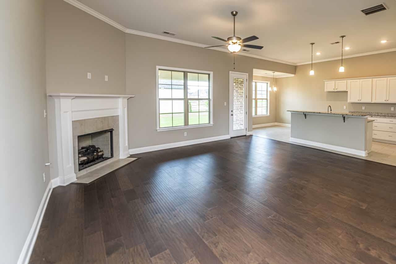 115 Misty Rdg Loop Oakland, TN 38060 - Photo 6 of 29 an empty room with wooden floor fireplace and windows