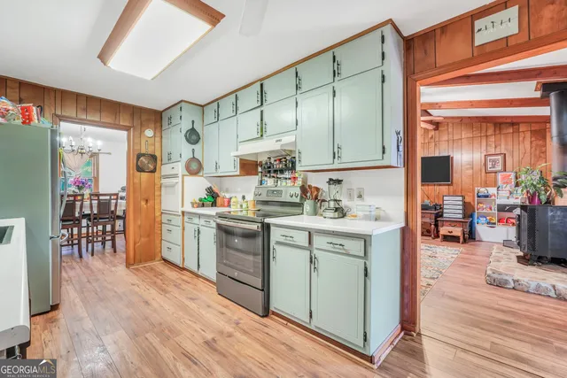 a kitchen with stainless steel appliances kitchen island granite countertop a stove a sink and a refrigerator