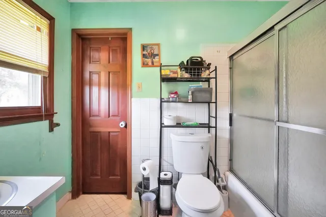 a bathroom with a toilet a sink and shower