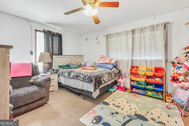 a bedroom with bed and a couch