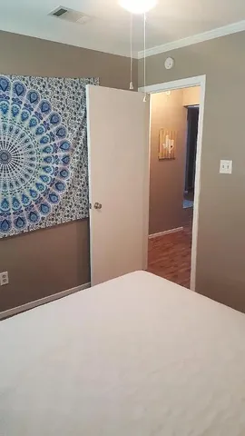 a view of empty room with wooden floor