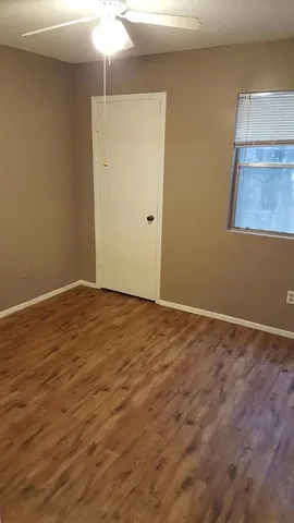 a view of an empty room with a ceiling fan