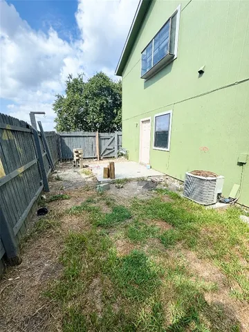 a backyard of a house with table and chairs