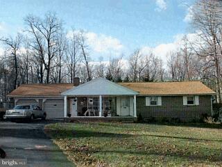 14244 Ingham Road New Freedom, PA 17349 - Photo 1 of 1 a front view of a house with a garden