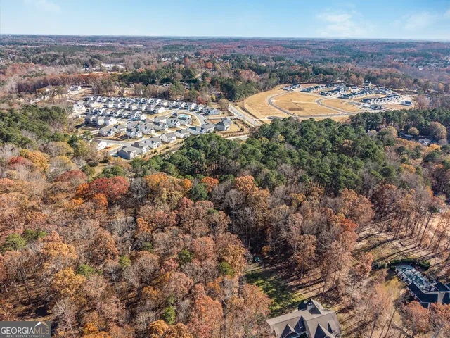 an aerial view of a residential houses with city view