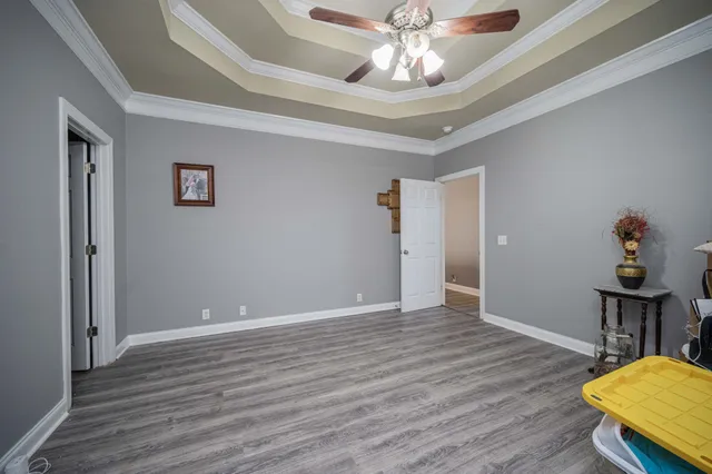 a view of an empty room with wooden floor