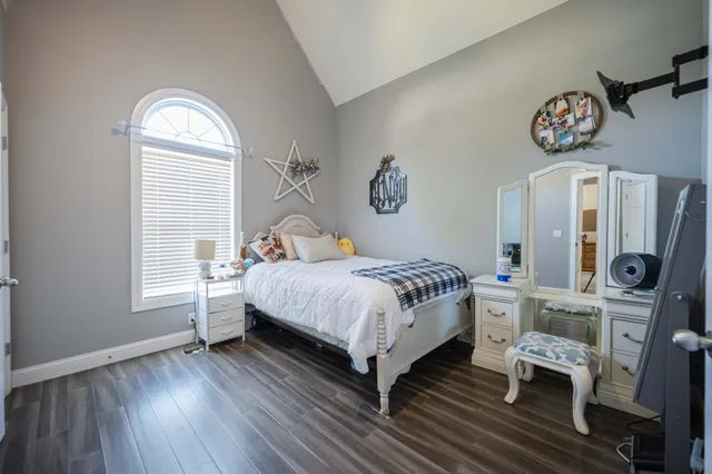 a bedroom with a bed and a window