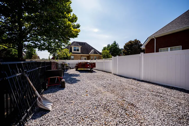 a backyard of a house with table and chairs