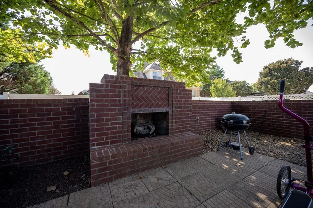 a backyard of a house with table and chairs