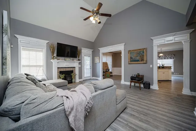 a living room with furniture a fireplace and a flat screen tv