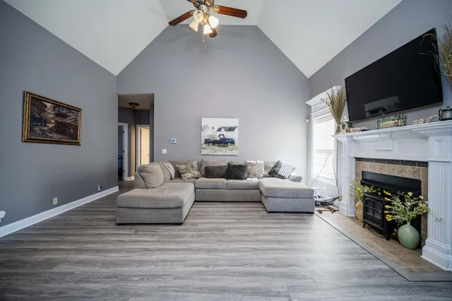 a living room with furniture a flat screen tv and a fireplace