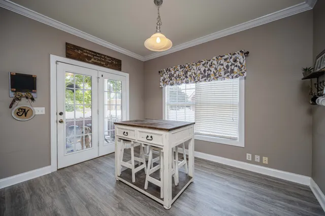 a view of a livingroom with wooden floor and a window