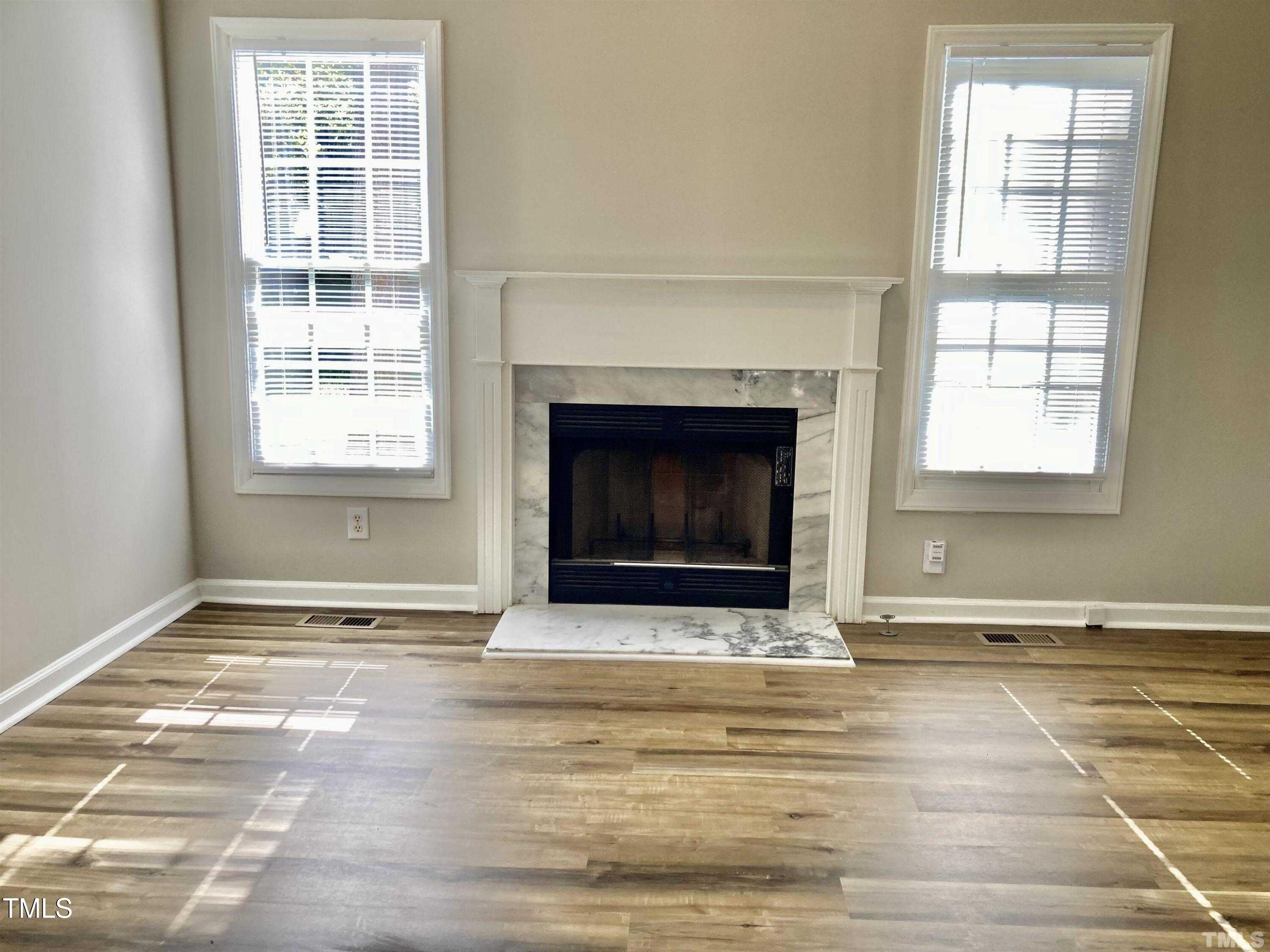 117 Mint Hill Drive Cary, NC 27519 - Photo 2 of 14 a view of an empty room with a fireplace and a window