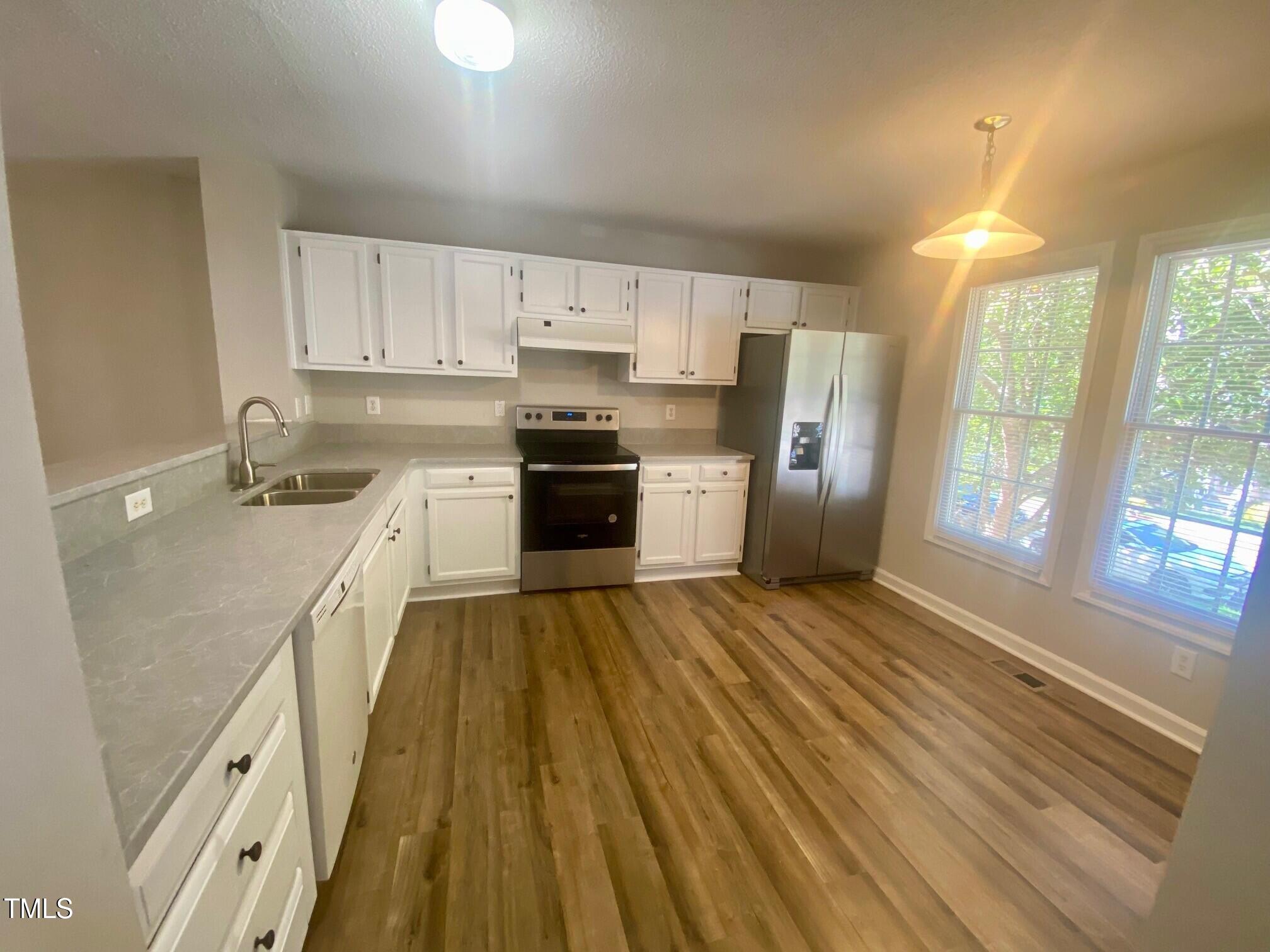 117 Mint Hill Drive Cary, NC 27519 - Photo 4 of 14 a kitchen with a sink a refrigerator and window
