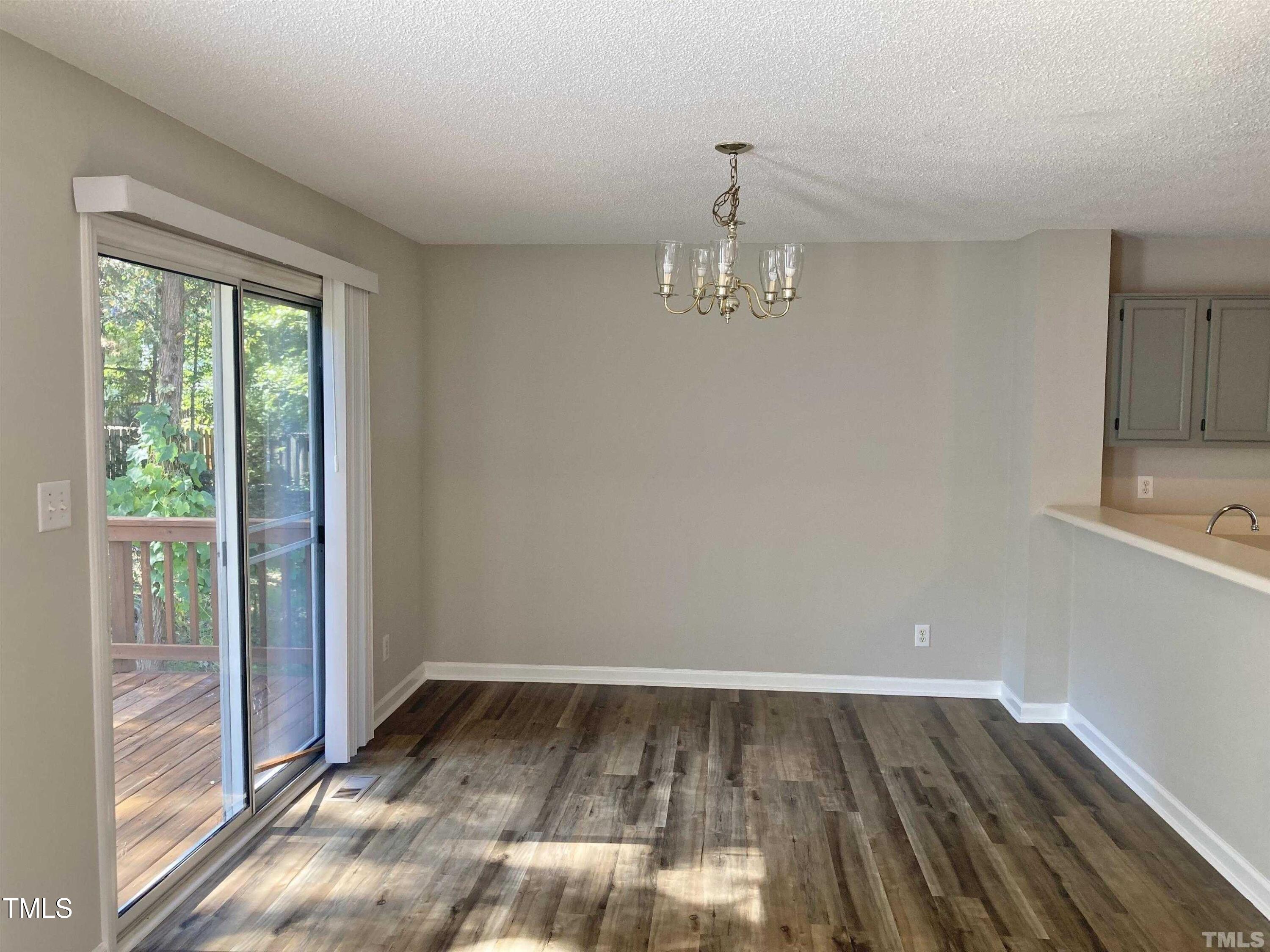 117 Mint Hill Drive Cary, NC 27519 - Photo 6 of 14 a view of empty room with wooden floor and fan
