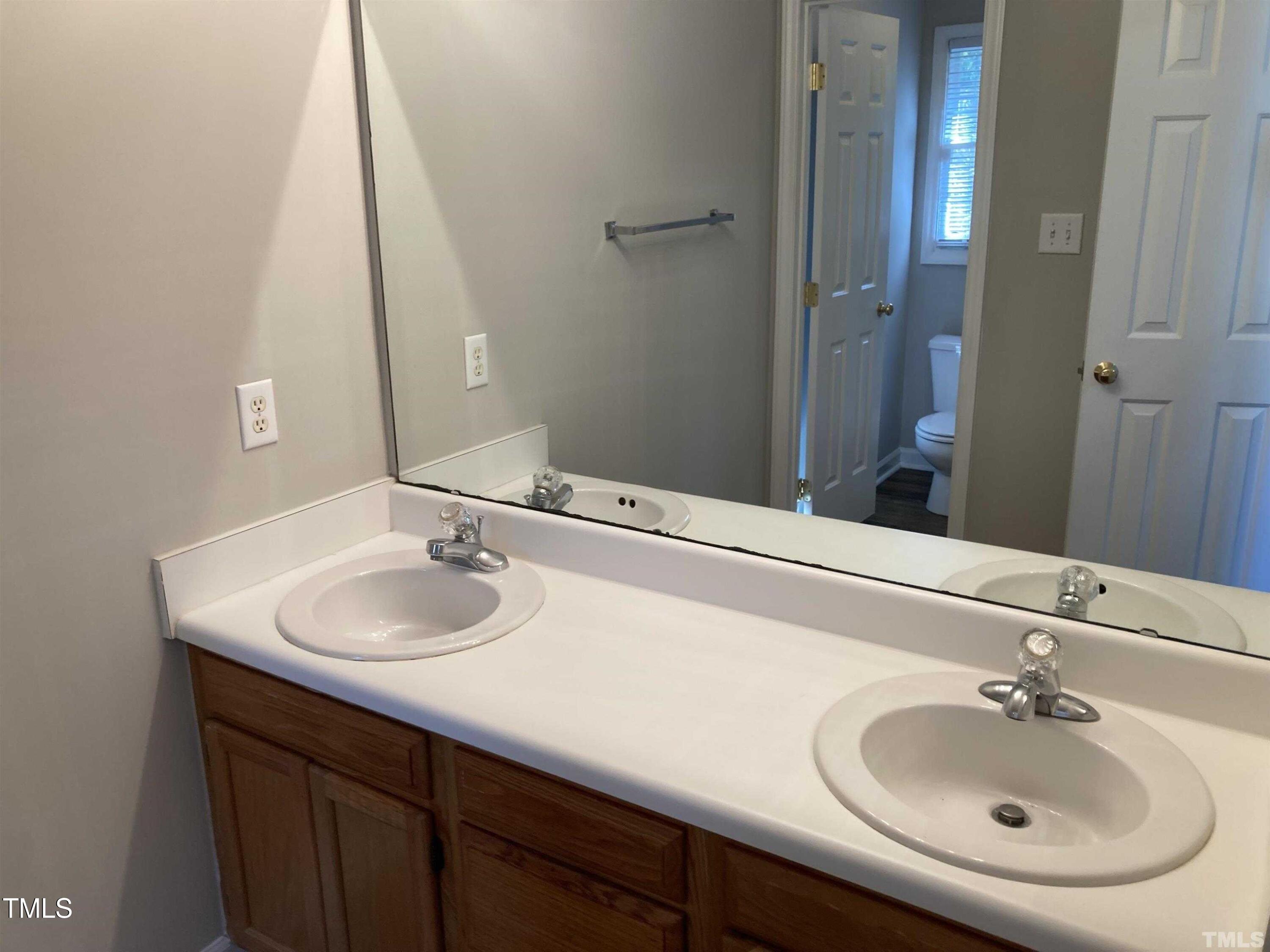 117 Mint Hill Drive Cary, NC 27519 - Photo 9 of 14 a bathroom with a sink and a mirror