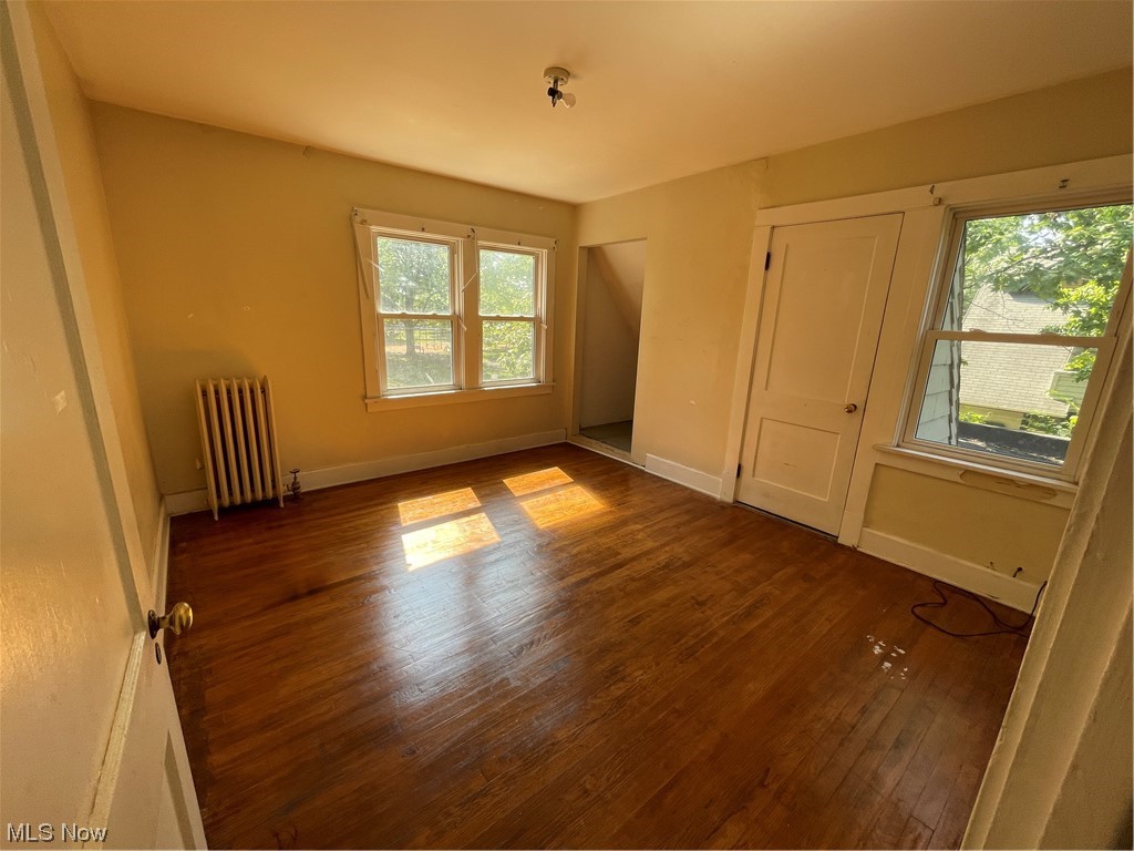 1730 Wood Road Cleveland Heights, OH 44121 - Photo 22 of 34 Unfurnished room featuring dark hardwood flooring and radiator