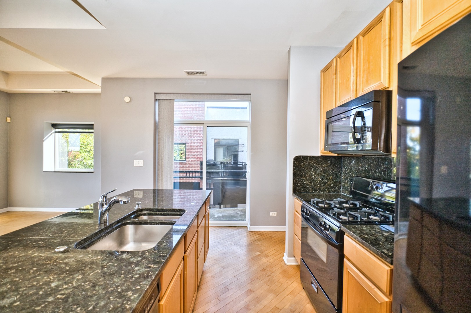 2317 West Wolfram Street, Unit 515 Chicago, IL 60618 - Photo 13 of 35 a kitchen that has a sink and a stove